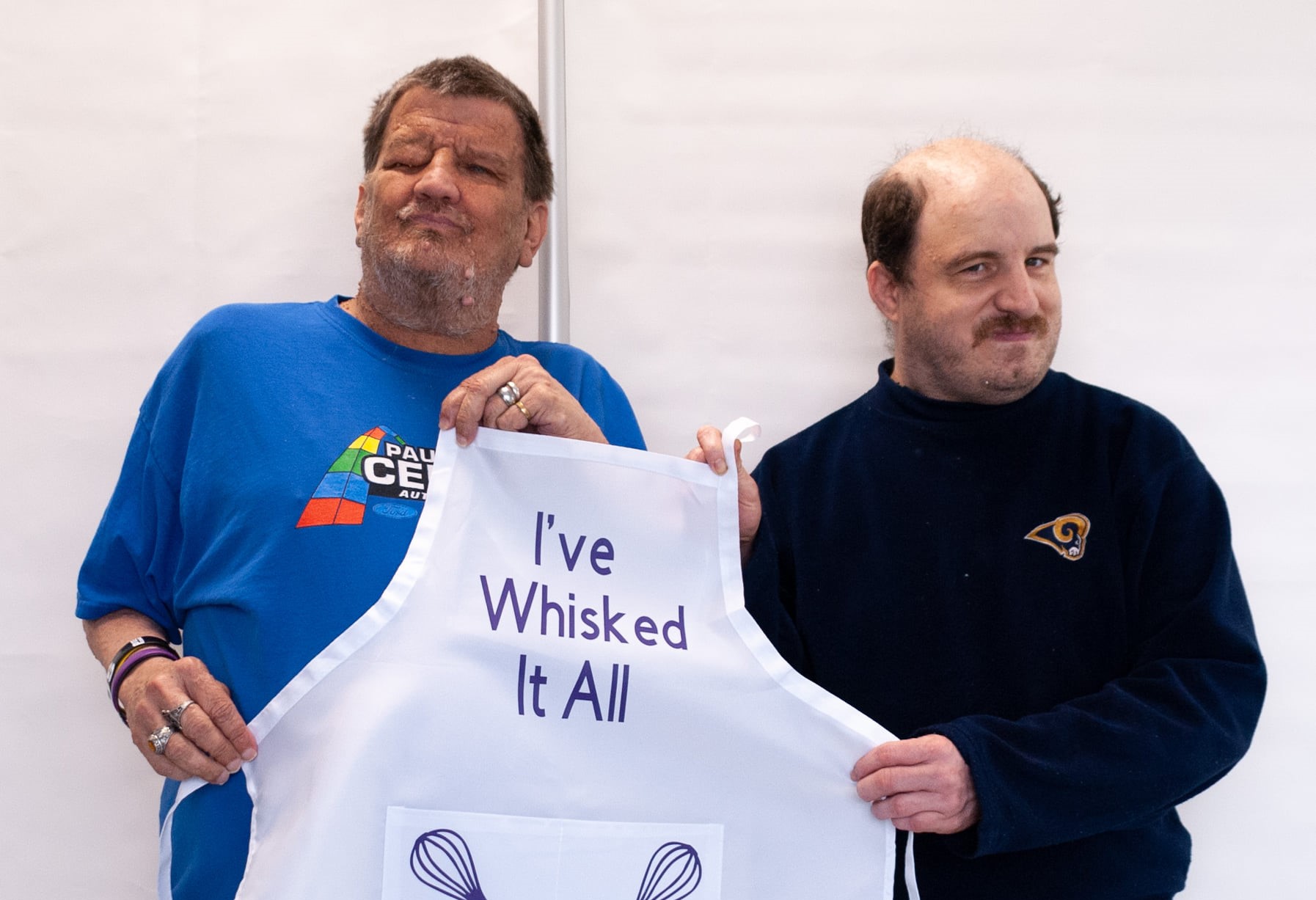 Individuals holding a personalized apron